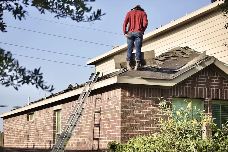 Professional roofer working on a residential roof in Engelwood Park